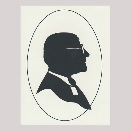 
        Front of silhouette, with man looking right, in suit and wearing glasses.